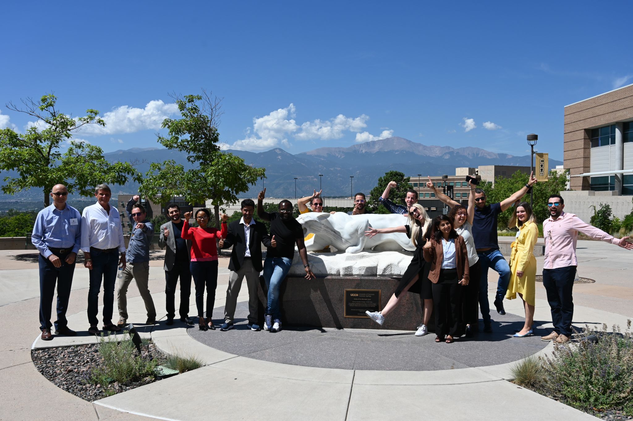 People posing in front of Marble mountain lion statue.
